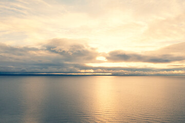 Obraz premium Aerial view clouds over the sea. Texture of clouds. View from above. Sunrise or sunset over clouds. Aerial ocean background