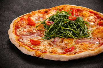 Pizza with bacon and rucola