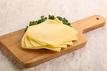 Sliced Gouda cheese over board