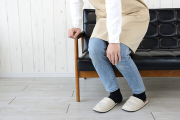 膝をおさえる主婦・立てずにふらつく主婦