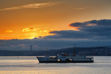 Early morning, sunrise over the sea. Sea boat sails through the Bosphorus. Istanbul, Turkey. Journey