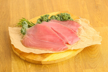 Raw salted tuna slice over board