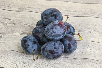 Ripe plum heap over background