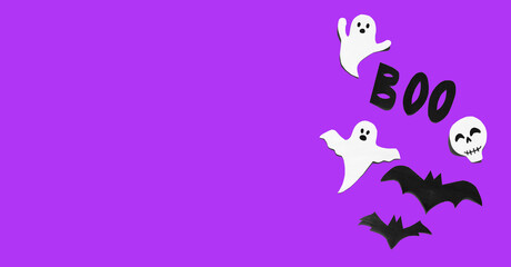 Fototapeta premium Halloween set decorations with ghost, bat, skeleton and word BOO on violet very peri background. Holiday party, minimal greeting card, spooky concept. flat lay, copy space, top view, place for text