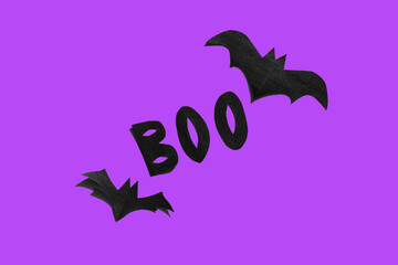 Halloween set decorations with bats and word BOO on yellow background. Holiday party, minimal greeting card, spooky concept. flat lay, copy space, top view, place for text
