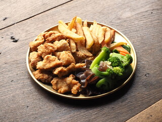 dish of fried chicken, fried potato, boiled broccoli, ear mushroom and carrot