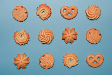 Tasty variety danish butter cookies on blue background.