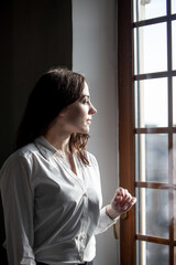 Office worker. Portrait of a woman in a office relaxing and thinking near window