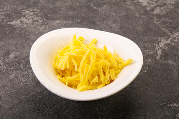 Shredded yellow cheese in the bowl
