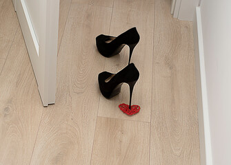 A pair of black women's high-heeled shoes. concept valentine's day