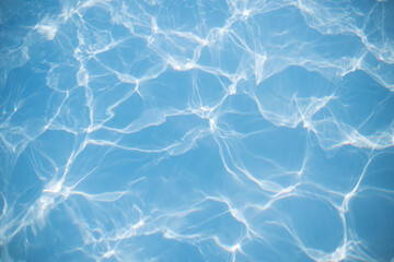 Bright blue azure water with waves in the sea. Colored water texture. Vacation concept