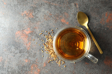 Concept of hot drink with buckwheat tea on dark textured background