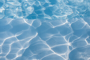 Blue water with ripples and waves in the pool. Ray abstraction in the water.