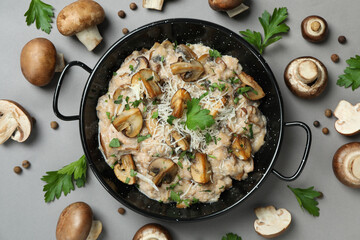 Concept of tasty food with risotto with mushrooms on gray background