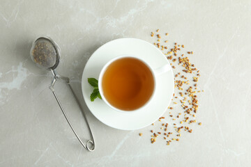 Concept of hot drink with buckwheat tea on light textured background