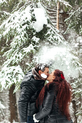 Fototapeta na wymiar Couple . Love. Valentine's day. Emotions. Man and woman playing in the snow. Couple in love in the winter forest