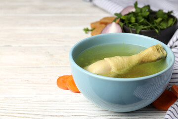 Concept of tasty food with chicken soup on white wooden table