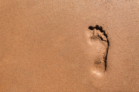 Human footprint in the sand on Mars. Life on the red planet. Male foot on the beach, top view. Copy space for text and design