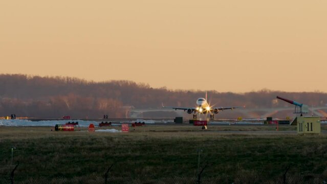 Commercial Jet Taking Off Beneath Orange Sky At Washington D.C.&rsquo;s DCA Airport