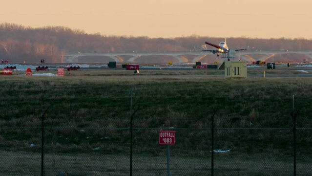 Commercial Jet Landing With Fence In Foreground In Washington D.C.
