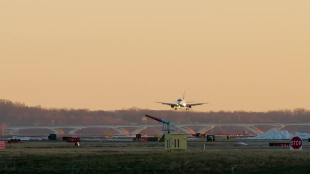 Commercial Jet Landing Beneath Orange Sky At Washington D.C.&rsquo;s DCA Airport