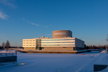 Icy sea and a theatre buiding in Oulu, Finland. Sunny day and blue sky.