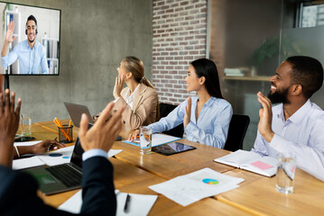 Videoconference Concept. Multiethnic business people making video call with colleague in office