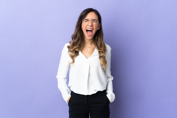Young caucasian woman isolated on purple background shouting to the front with mouth wide open