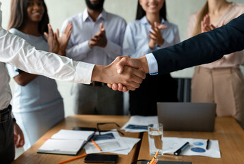 Successful Deal. Closeup Shot Of Two Man Handshaking At Group Corporate Meeting