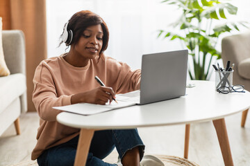 African Woman Learning At Laptop Computer Taking Notes At Home