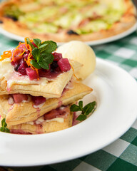 Puffs with ricotta and melon, decorated with powdered sugar and mint leaves.