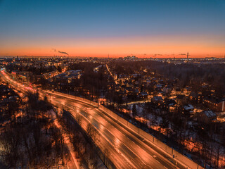 Fototapeta na wymiar Panoramic sunset at winter over the city of Helsinki, highway at night, traffic in the city