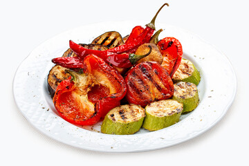 Grilled roasted vegetables on a white plate.  Sweet peppers, tomatoes, zucchini, eggplant.