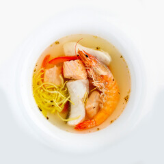 Fish soup with salmon, perch and king prawns. Top view