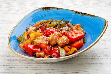 Asian-style chicken with sweet and sour sauce and vegetables.