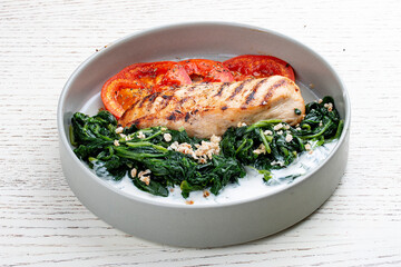 Fried chicken fillet with Greek dzadziki sauce and stewed spinach.