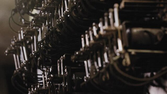 Close up view of elevator switchgear of a manual elevator located inside a dark room of the building.