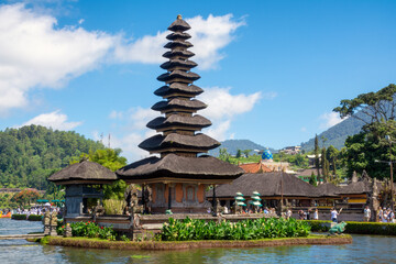Fototapeta na wymiar Bali water temple on Bratan Lake is the most beautiful temple in Bali, Indonesia. Pura Ulun Danu Beratan Temple, or Pura Bratan is located by the lake and surrounded by forested mountains.