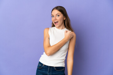 Young Lithuanian woman isolated on purple background celebrating a victory