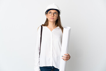 Young Lithuanian architect woman with helmet and holding blueprints isolated on white background and looking up