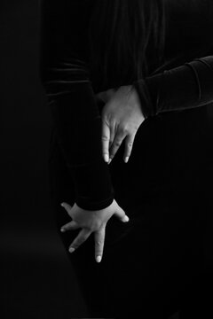 Close-up of women's hands. A black and white frame with a slight blur and defocus on the image. Details of body, fashion and art