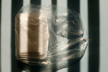Close up white styrofoam lunch box inside transparent plastic bag