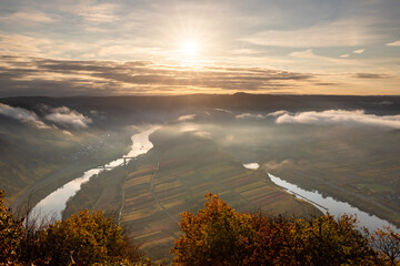 The Moselle Loop in Rhineland-Palatinate, Germany. Beautiful landscape shot at sunrise with fog in...