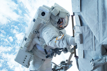 Astronaut in outer space is shooting the Earth. Elements of this image were furnished by NASA