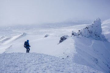 Naklejka na ściany i meble Hiker at the Avachinsky Pass and volcanoes in Kamchatka