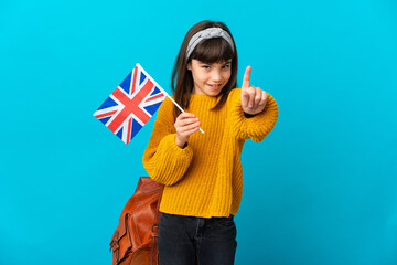 Little girl studying English isolated on blue background showing and lifting a finger