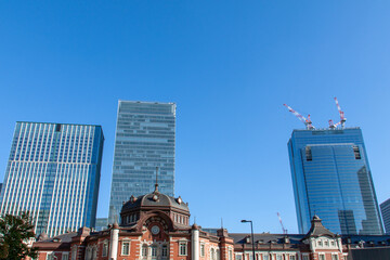 Tokyo station and high-rise buildings under the blue sky