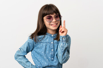 Little girl with sunglasses isolated on white background showing and lifting a finger in sign of the best