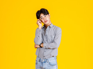 Studio shot of millennial Asian thoughtful doubtful curious male fashion model in stylish...