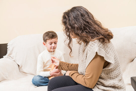 Woman Taking A Nasal Swab From A Child.